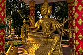 Vientiane, Laos - Pha That Luang, various Buddha statues among the Other structures on the ground. 